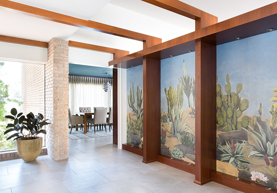 Hallway with desert scenery painted on the wall.