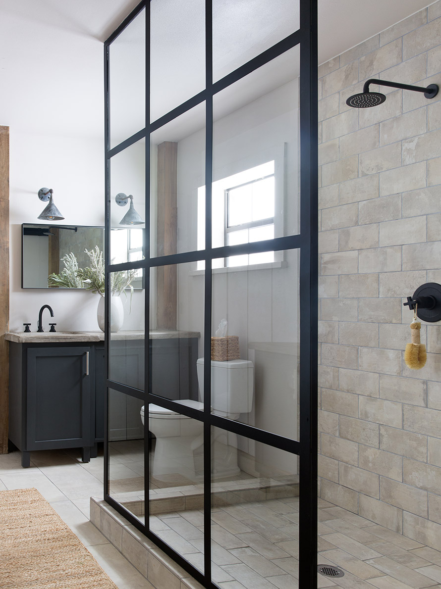 Tile shower with glass wall.
